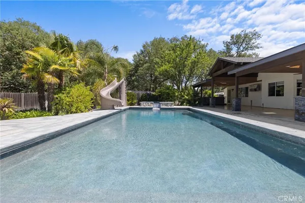 a view of a swimming pool with a yard