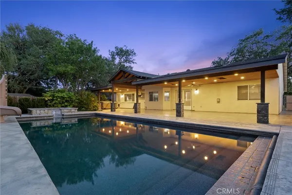 an aerial view of residential house with outdoor space and swimming pool