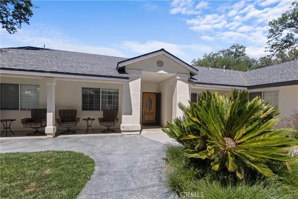an aerial view of a houses with a yard