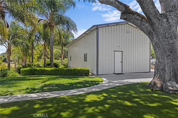 a view of a house with swimming pool and next to a yard