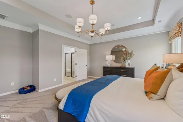 a bedroom with a bed window and couch