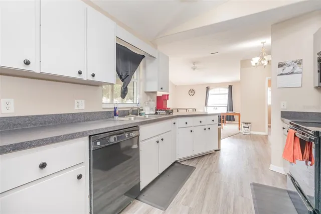 a kitchen with granite countertop a sink cabinets stainless steel appliances and a counter space