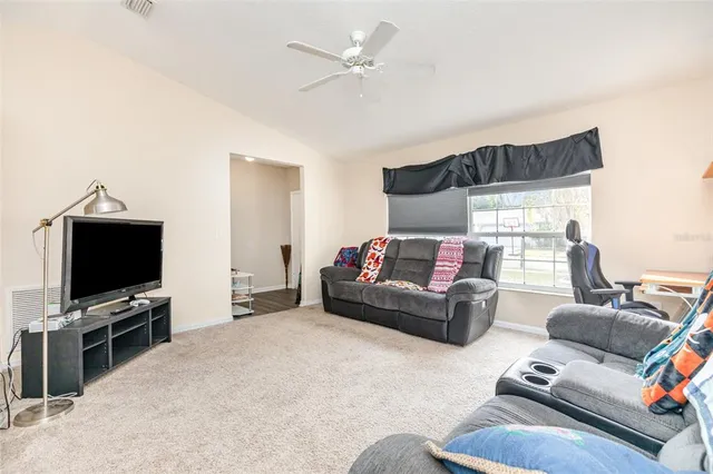 a bedroom with furniture and a flat screen tv