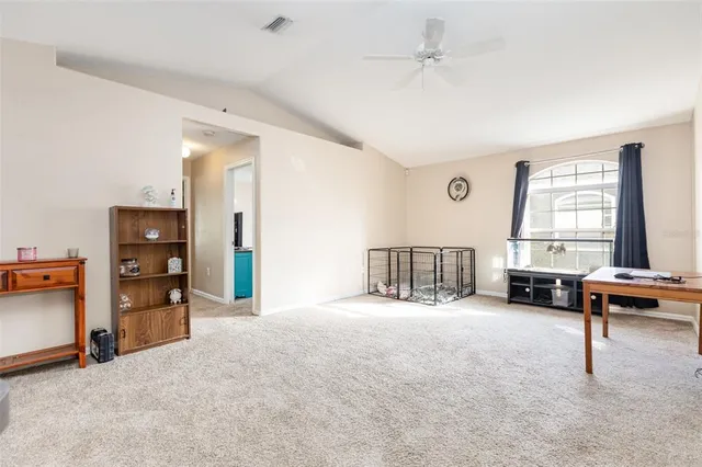 a view of a livingroom with furniture and a window