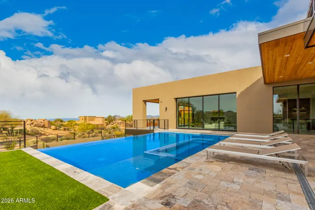 a view of swimming pool with a table under an umbrella