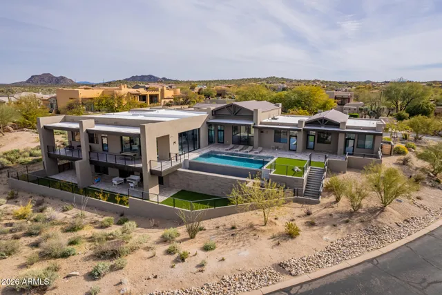 aerial view of a house with a swimming pool and sitting area