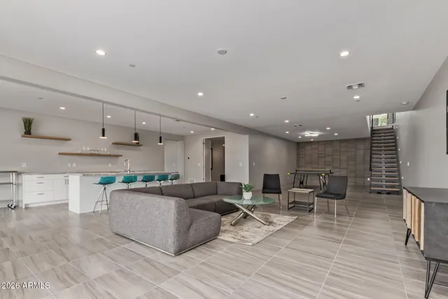 a large kitchen with stainless steel appliances kitchen island granite countertop a large kitchen island a stove a sink a dining table and chairs