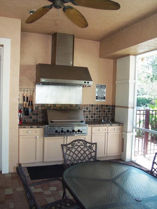 6552 Moorings Point Circle, Unit 102 Lakewood Ranch, FL 34202 - Photo 41 of 57 a kitchen with a stove and a microwave