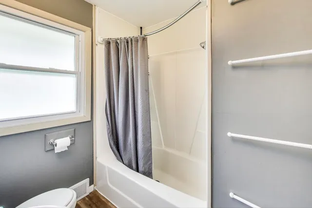 a bathroom with a shower and a toilet