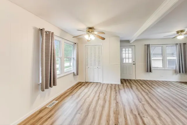 wooden floor in an empty room with a window