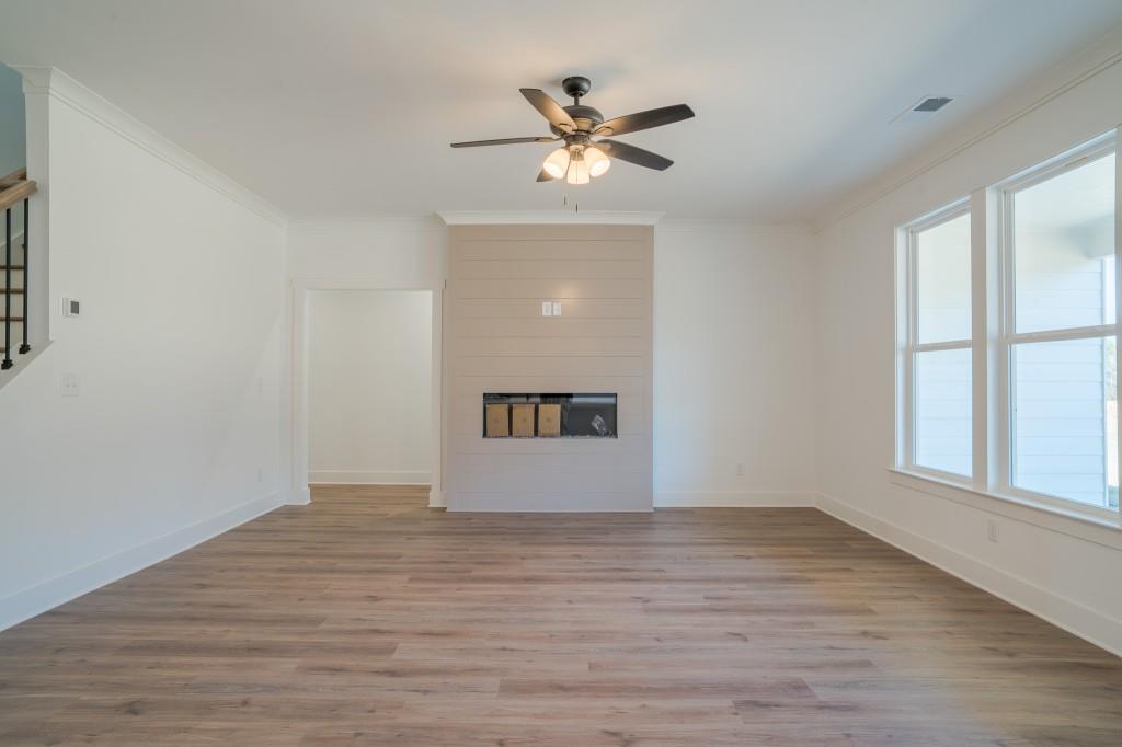 93 Tomahawk Trail Good Hope, GA 30641 - Photo 17 of 61 a view of an empty room with wooden floor and a window