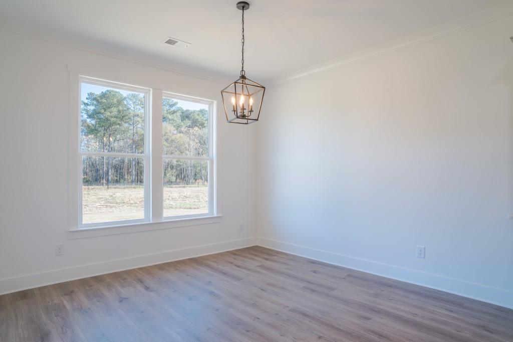 93 Tomahawk Trail Good Hope, GA 30641 - Photo 18 of 61 a view of an empty room with wooden floor and windows