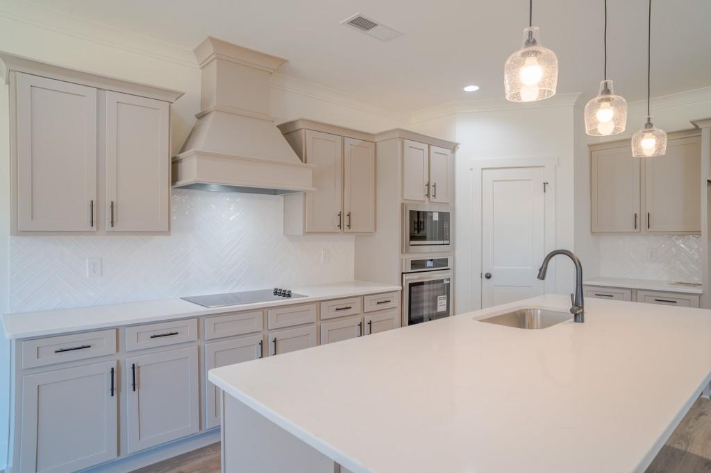 93 Tomahawk Trail Good Hope, GA 30641 - Photo 20 of 61 a kitchen with kitchen island a sink stainless steel appliances and cabinets