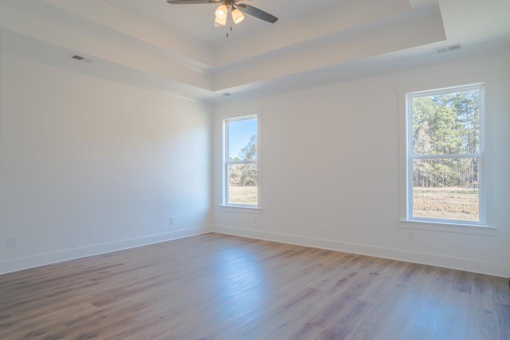 93 Tomahawk Trail Good Hope, GA 30641 - Photo 23 of 61 a view of an empty room with wooden floor and window