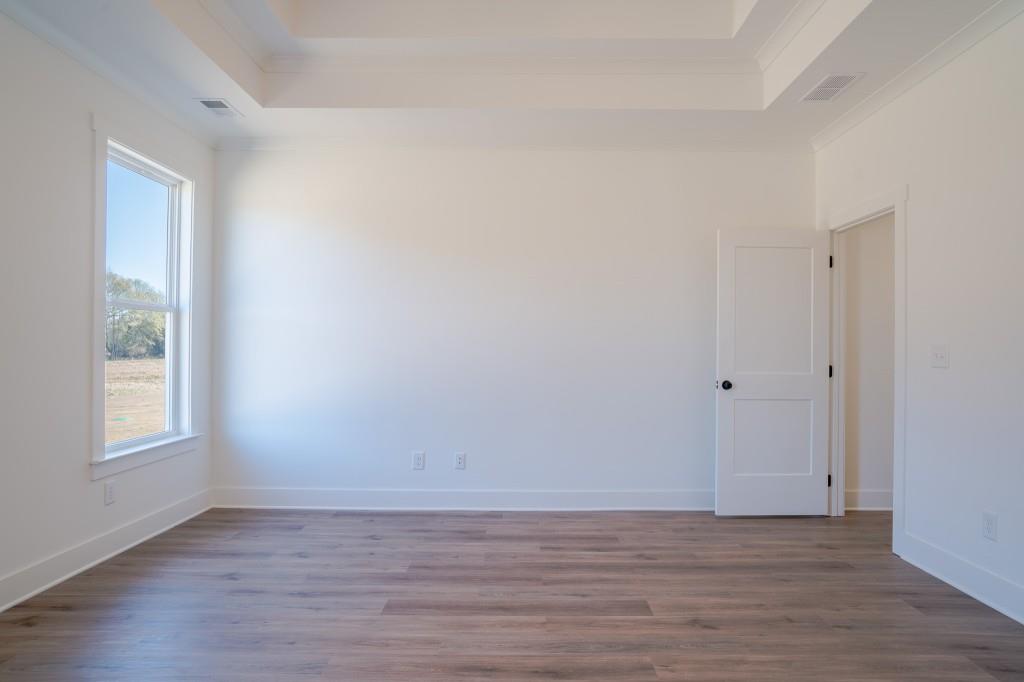 93 Tomahawk Trail Good Hope, GA 30641 - Photo 26 of 61 a view of an empty room with wooden floor and a window