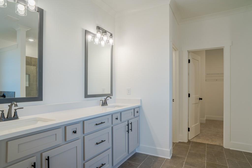 93 Tomahawk Trail Good Hope, GA 30641 - Photo 27 of 61 a bathroom with a double vanity sink and mirror