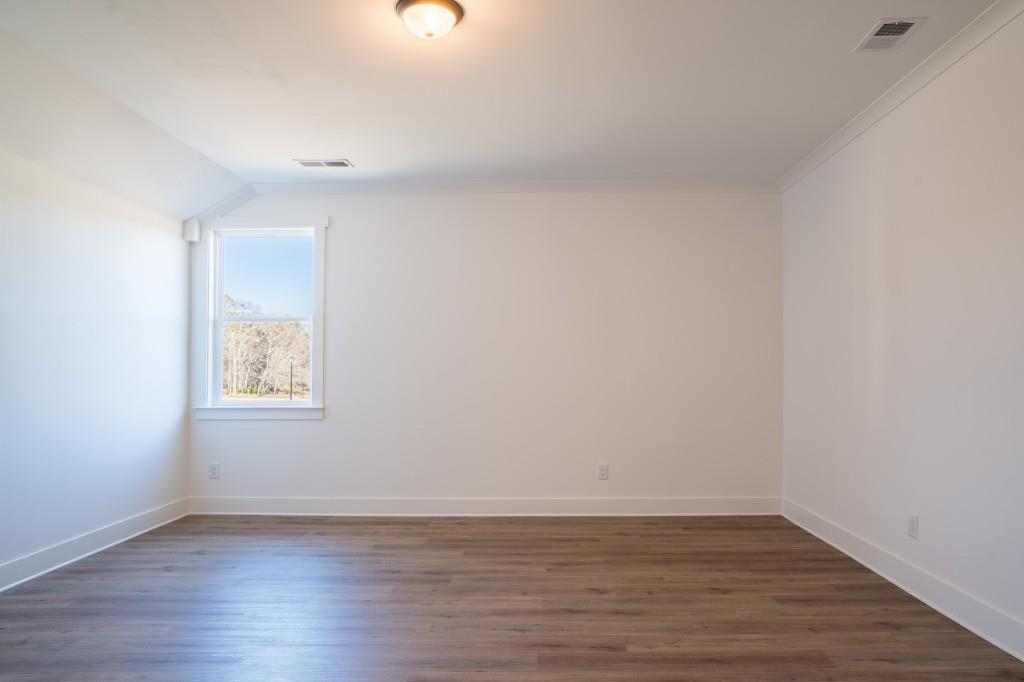 93 Tomahawk Trail Good Hope, GA 30641 - Photo 38 of 61 a view of an empty room with wooden floor and a window