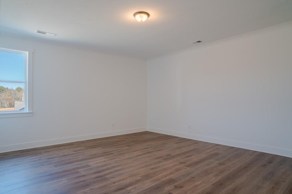 93 Tomahawk Trail Good Hope, GA 30641 - Photo 39 of 61 a view of an empty room with wooden floor and a window