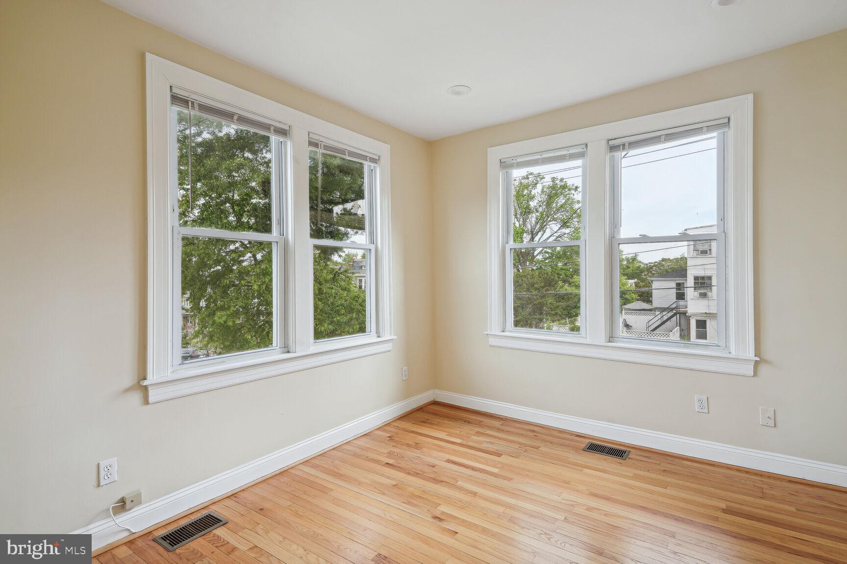 4528 4th Street Northwest Washington, DC 20011 - Photo 12 of 28 a view of an empty room with wooden floor and a window