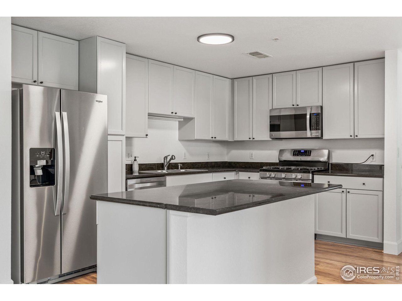 4500 Baseline Road, Unit 2107 Boulder, CO 80303 - Photo 7 of 34 a kitchen with stainless steel appliances granite countertop a refrigerator a stove a sink and a granite counter tops