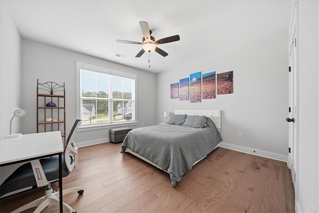 214 Timothy Court Anderson, SC 29621 - Photo 23 of 43 An inviting bedroom features rich hardwood flooring and a bright window with blinds.