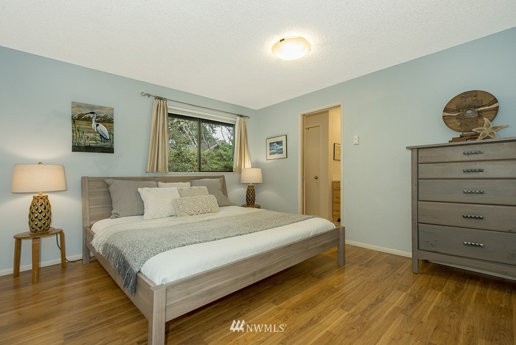 4336 Southwest Luana Beach Road Vashon, WA 98070 - Photo 13 of 40 a bedroom with a bed and wooden floor