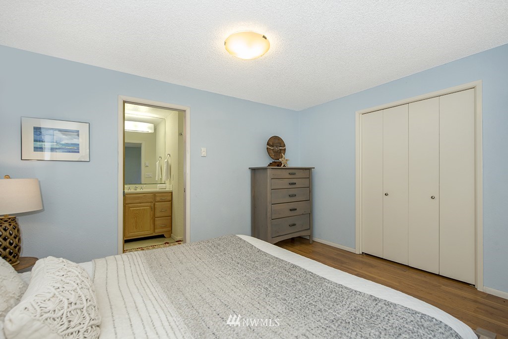 4336 Southwest Luana Beach Road Vashon, WA 98070 - Photo 14 of 40 a bedroom with a bed and a dresser