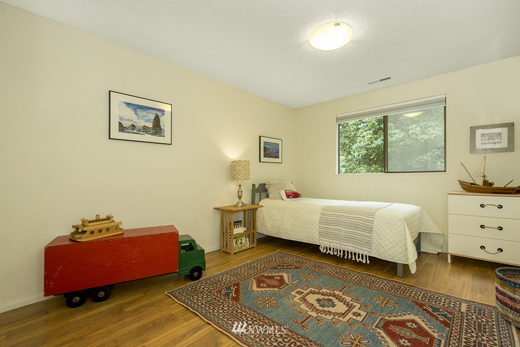 4336 Southwest Luana Beach Road Vashon, WA 98070 - Photo 17 of 40 a bedroom with furniture and a window