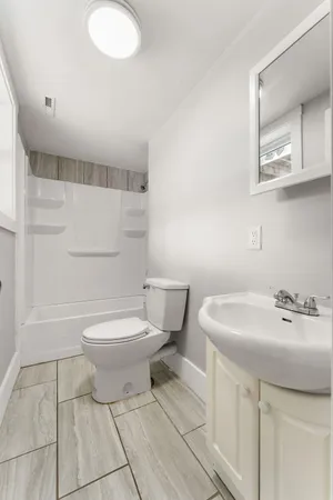 a bathroom with a sink toilet and shower