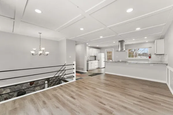 a view of kitchen with refrigerator and window