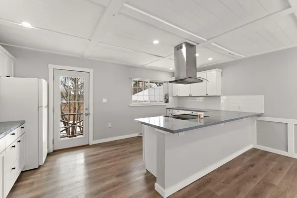 a kitchen with a stove and a refrigerator