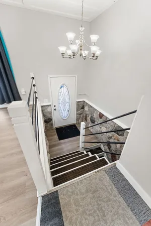 a view of entryway and hall with wooden floor