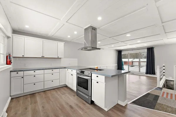 a kitchen with stainless steel appliances granite countertop a stove sink and cabinets