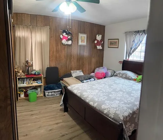 a bedroom with bed and a mirror