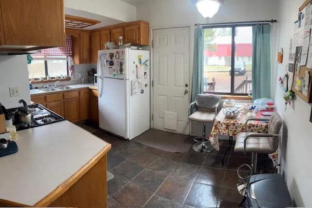 a kitchen with a refrigerator and a stove