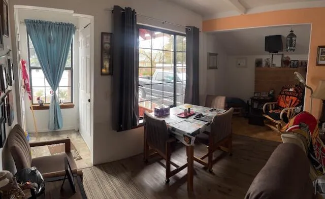 a view of a dining room with furniture window and wooden floor