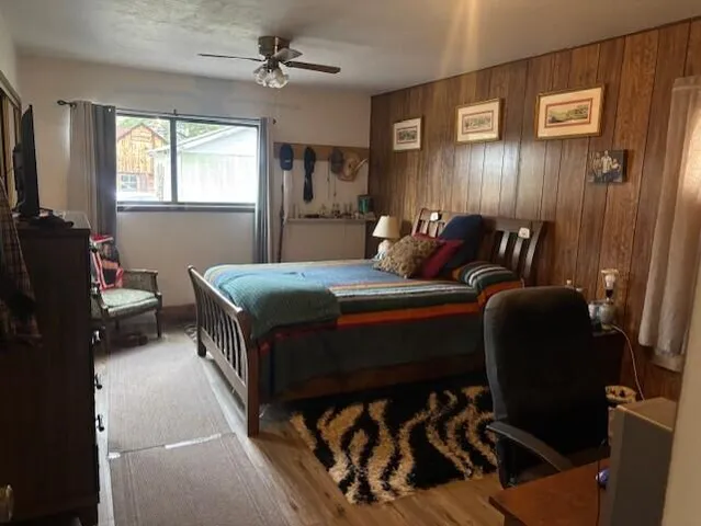 a bedroom with a bed and a painting on the wall