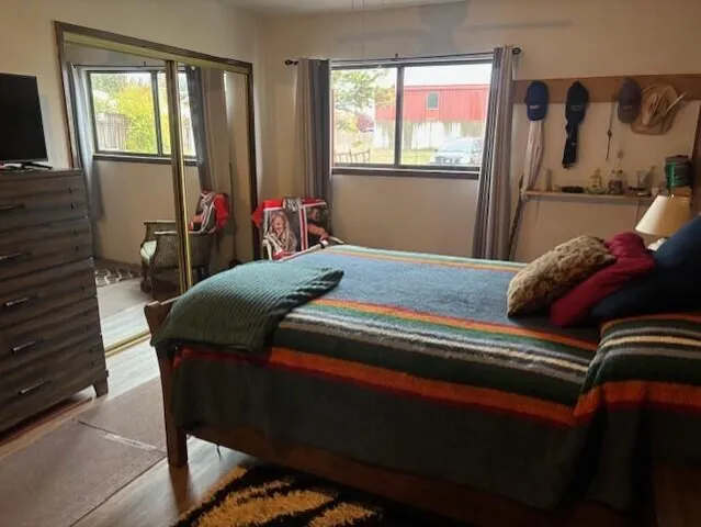 a bed room with furniture and flat screen tv