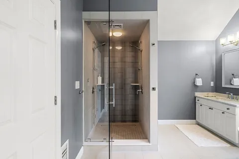 a bathroom with a shower and a sink
