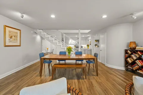 a dining room with furniture and wooden floor
