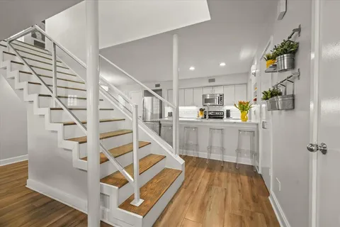 a view of kitchen with furniture and wooden floor