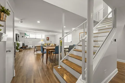 a view of entryway dining room and hall with wooden floor