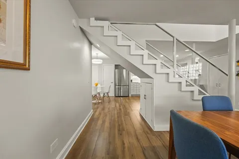 a view of entryway and hall with wooden floor