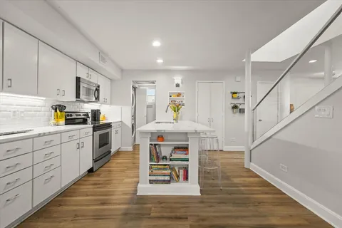 a kitchen with a sink a stove and cabinets