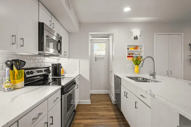 a kitchen with a sink a counter and chairs