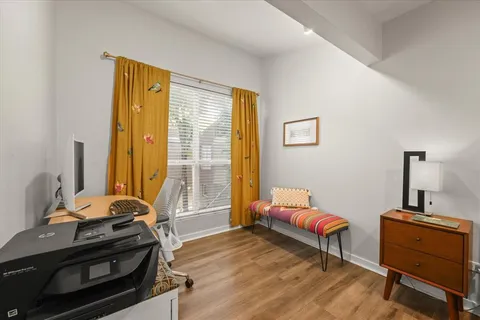 a bedroom with bed and flat tv with dresser