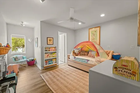 a view of a bedroom with furniture and wooden floor