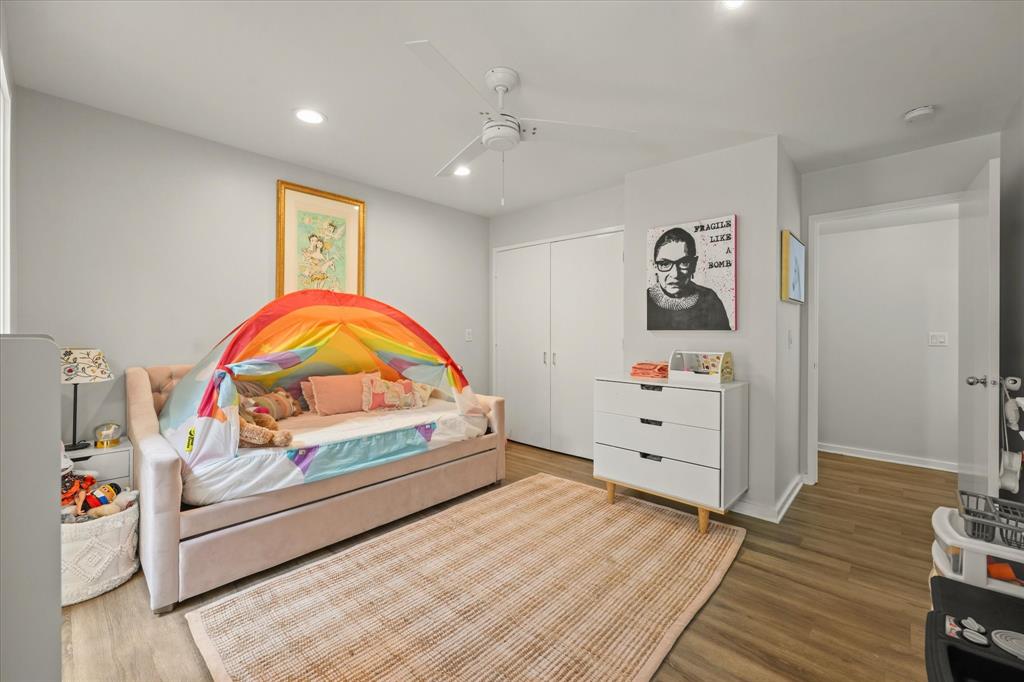 4231 Travis Street, Unit 29 Dallas, TX 75205 - Photo 29 of 39 a view of a bedroom with furniture and wooden floor