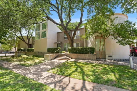 a view of backyard of house with outdoor seating and trees
