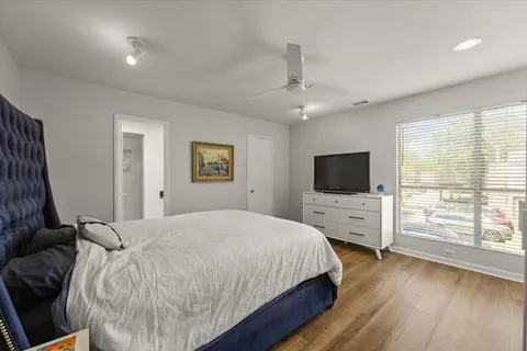 a bedroom with a bed and a flat screen tv in it